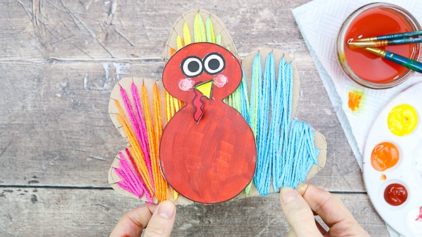 Yarn Wrapped Turkey Craft: A tactile craft for Thanksgiving - Incorporating painting, cutting, threading and sticking, there's plenty to keep children busy, and strengthen little ones fine motor skills whilst they're at it. And children will love getting so hands-on and creative with the different elements.