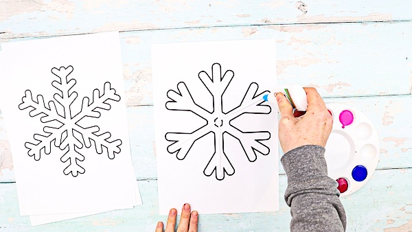 Print the snowflakes templates. 

Create gluey lines within the snowflake.