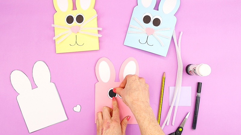 Image showing hands gluing the bunny eyes.