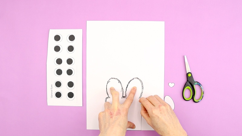 Imagine showing the first bunny shape being traced with a black crayon - positioned in the centre bottom of a sheet of white card stock.