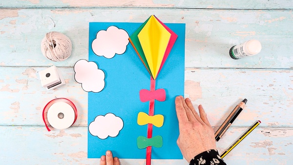 Image showing a 3D kite with a ribbon affixed to its back. 3 bows have been glued to the ribbon - all evenly spaced.