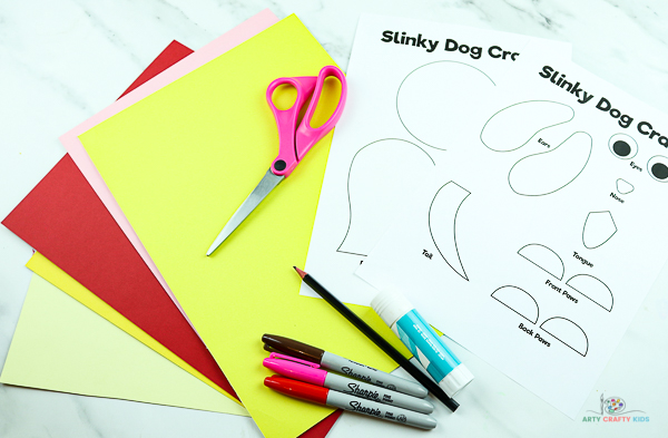 Download the slinky dog craft template and gather supplies.