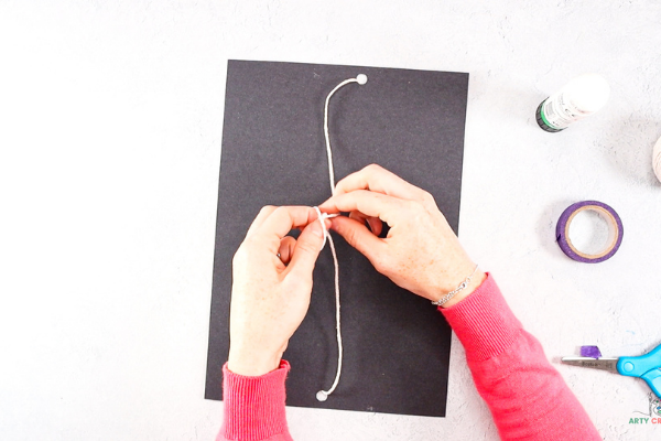 Turn the space backdrop over and secure the string with a knot.