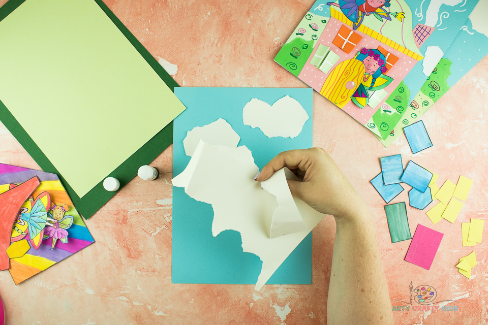 Image showing white paper being torn in to a cloud shape.