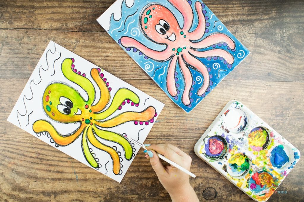 Image showing bright orange, green and pink paint being painted on to the Octopus drawing.