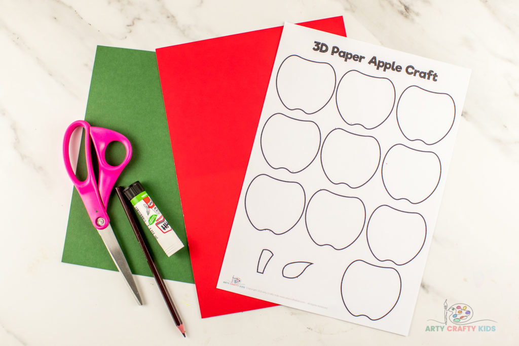 Image showing scissors, pencil, glue stick, red and green card, and printable 3D Paper Apple Craft template.