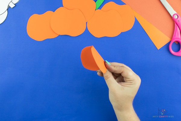 Image showing the first pumpkin shape folded in half.