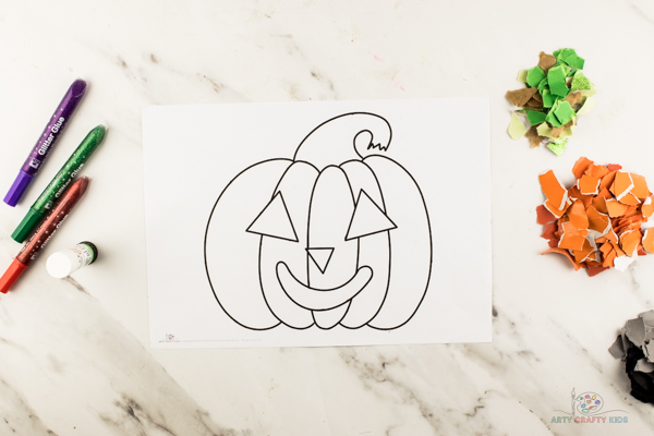 Image showing our printable pumpkin template, and piles of torn colored paper.