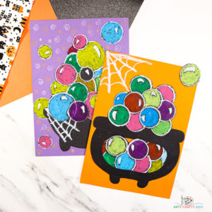 Our latest Halloween craft uses just a few materials you’re likely to already have in the arts and crafts supplies box, and while it’s low key on materials, the use of color contrast transforms a simple concept into a high impact art idea for kids!