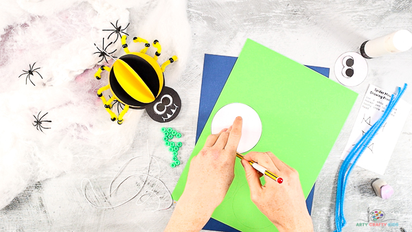 Image showing the spider's body being traced onto colored card stock.