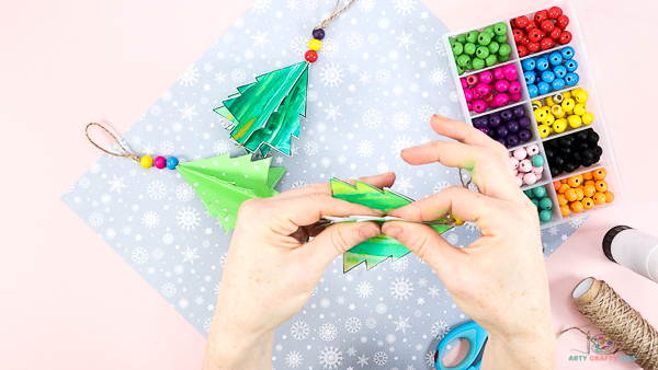 Image showing hands folding the remaining Christmas tree halves to form the Christmas Tree Bauble.