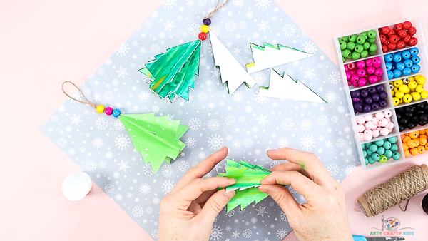 Image showing hands aligning the Christmas tree folds.