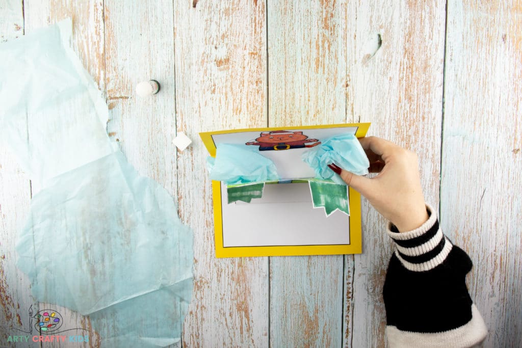 Image showing tissue paper being added to the inside of the present.