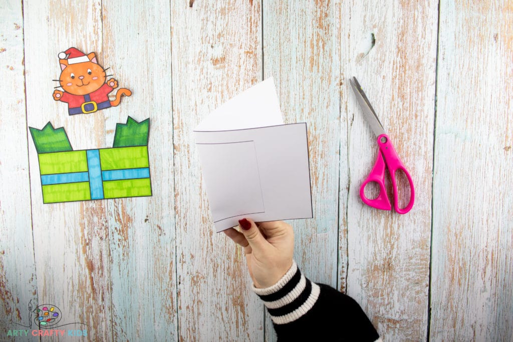 Image showing a pair of hands holding a folded card template.