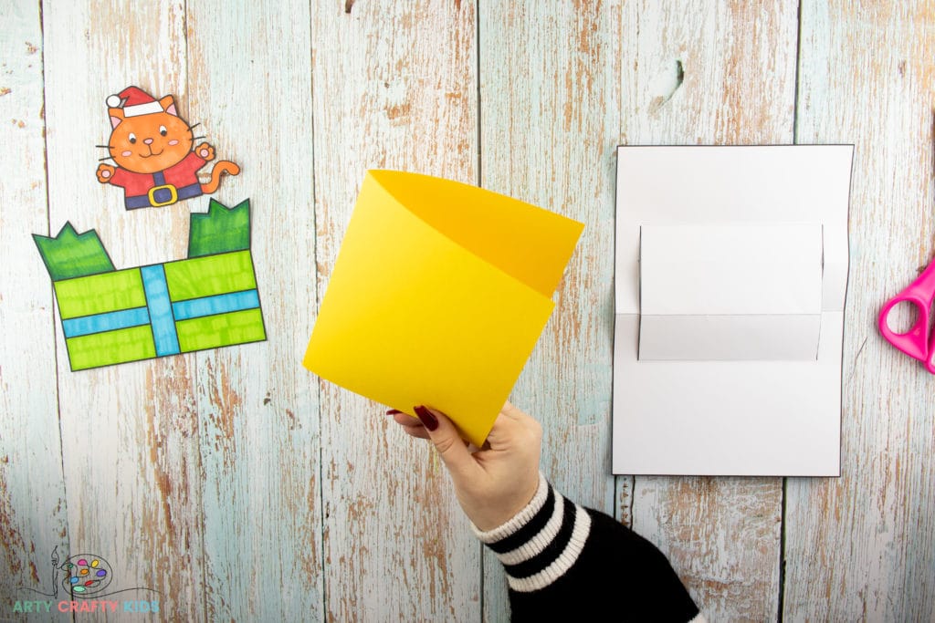 Image showing hands holding a piece of yellow card.