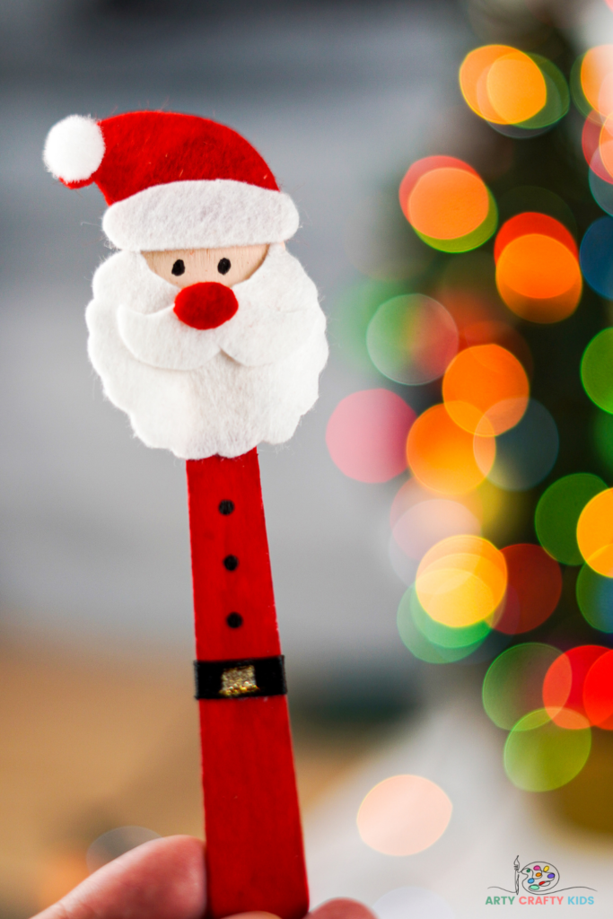 Learn how to make a popsicle stick Santa craft. A lovely fun and easy Christmas craft for kids, with Santa doubling up as a Christmas ornament, puppet or bookmark.