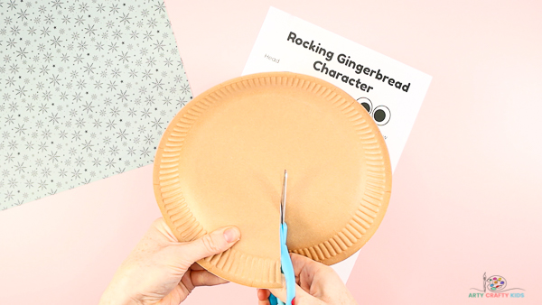 Image showing hands cutting half way into a paper plate.