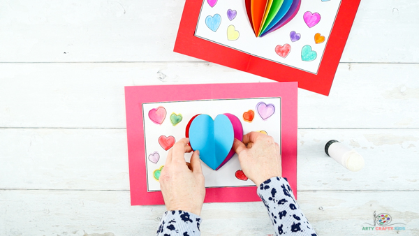Image showing hands opening up the folded layered hearts to reveal the complete shape and pop up effect.