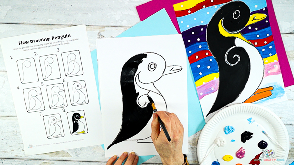 Image showing a hand painting the penguin black.