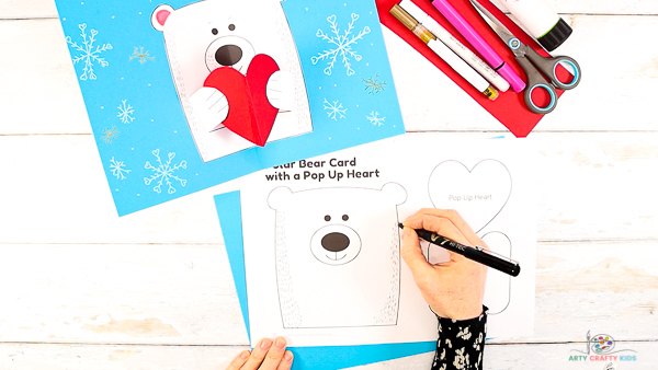 Image showing a hand decorating the polar bear template.