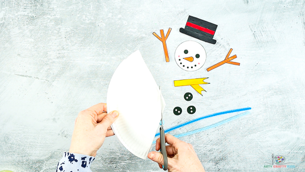 Image showing hands cutting the tip of the paper plate cone.