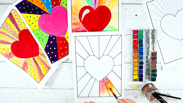 Image showing hands applying red, orange and yellow watercolor paint to the bottom rays.