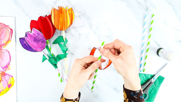 Image showing hands flattening the tip of the paper straw.