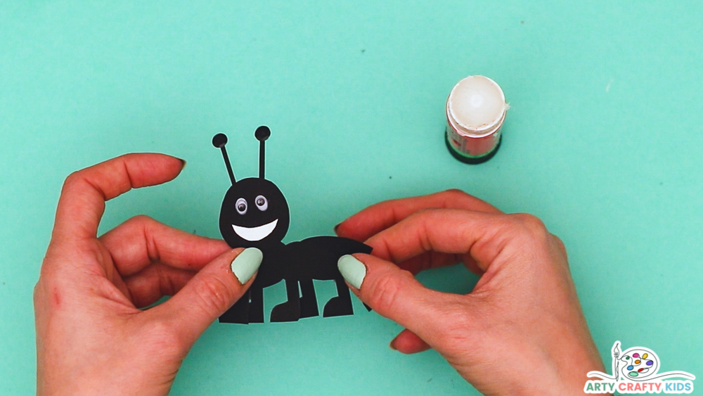 Image showing hands completing the ant with six legs.