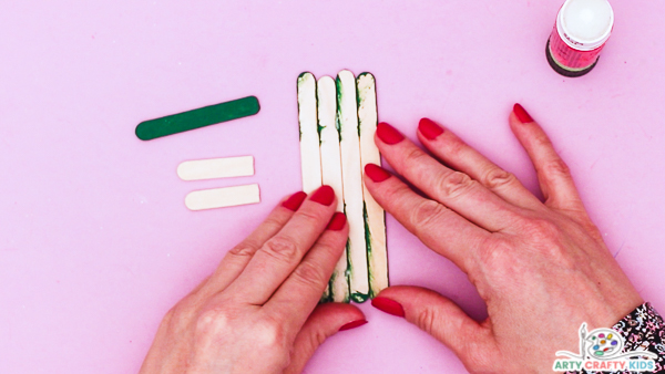 Image showing hands aligning the turned over painted sticks.