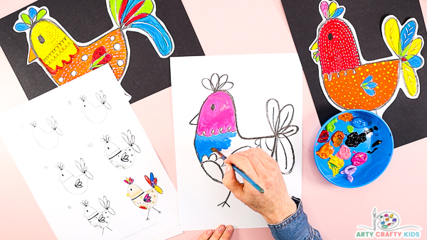Image showing hands painting the chicken right pink and blue.