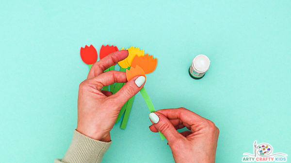 Image showing hands gluing the tulip heads onto stems.