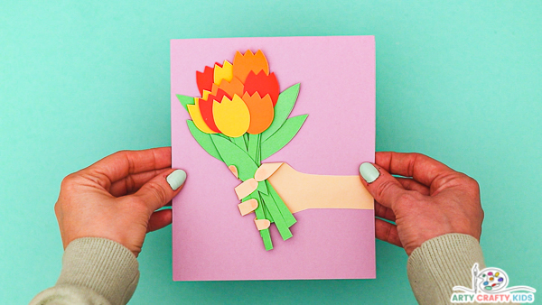 Image hands holding a completed Mother's Day Flower Card.
