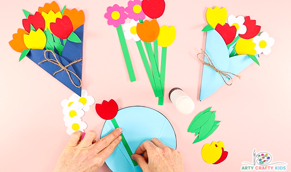 Image showing hands gluing a red tulip to the inside of the bouquet. 