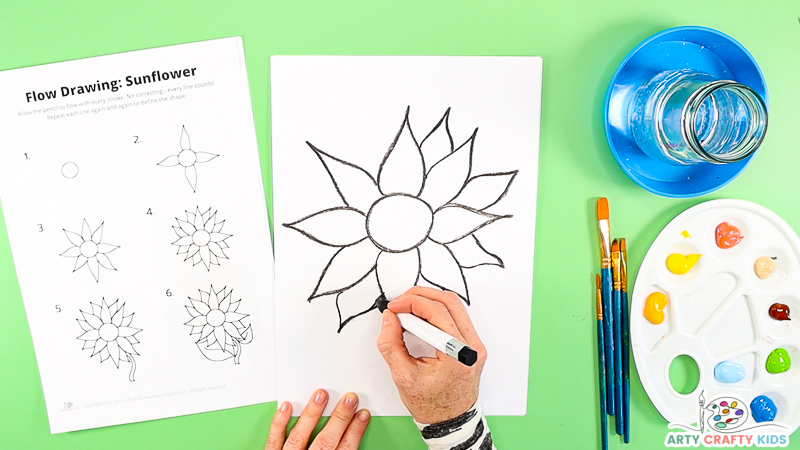 Image showing a hand drawing the outer ray flowers.