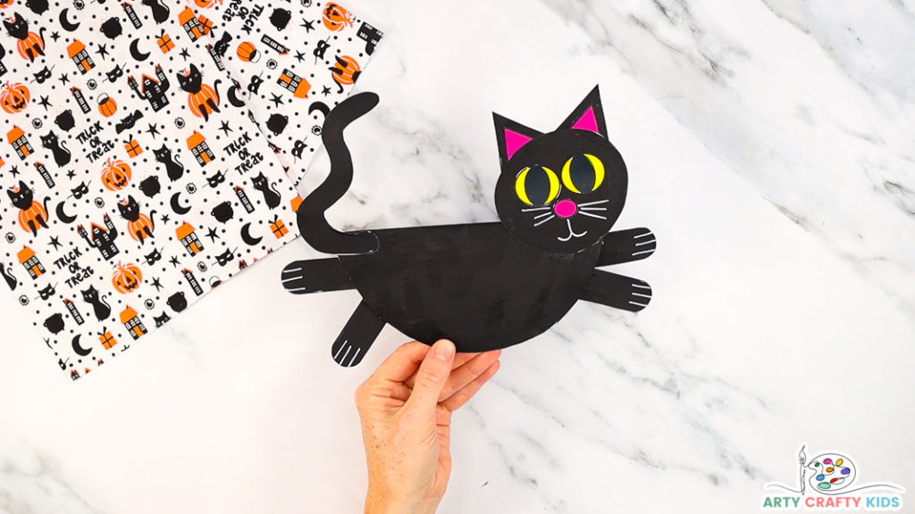 Step 9: Affix the Cat's Tail 

The rocking paper plate black cat craft is complete.