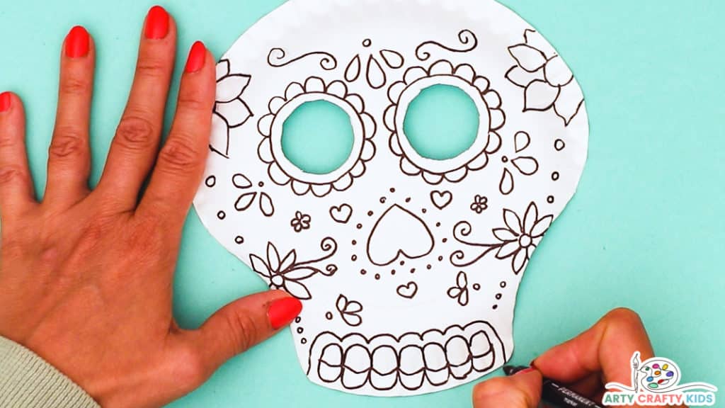 Step 4: Decorate the Skull with Small Flowers and Draw Teeth within the Chin Area 