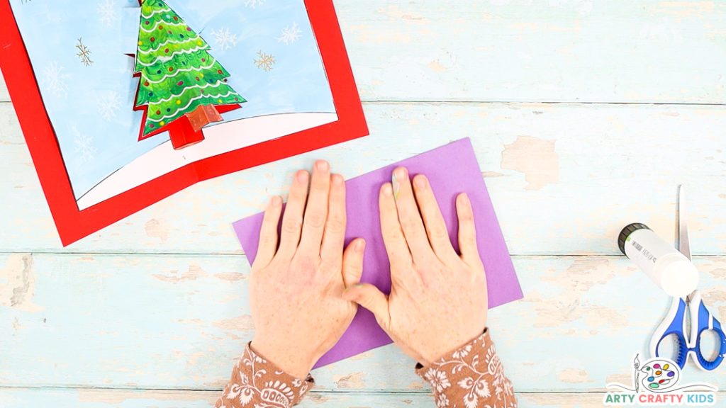 Step 11: Carefully Fold the Card in Half, Again Pulling the Christmas Tree Gently Away from the Center