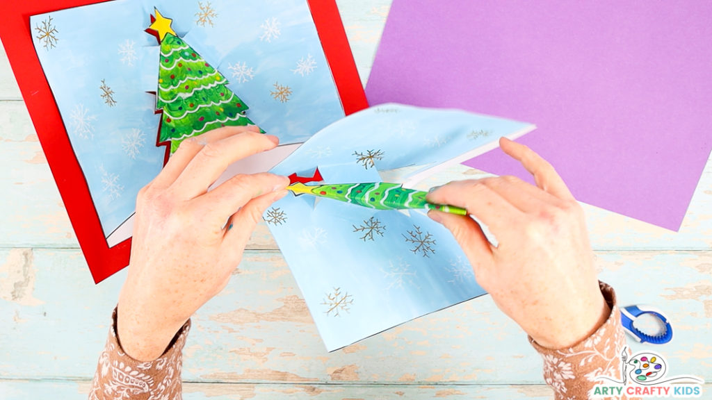 Step 8: Fold the Card Back on Itself and Pull the Christmas Tree Away from the Center Fold