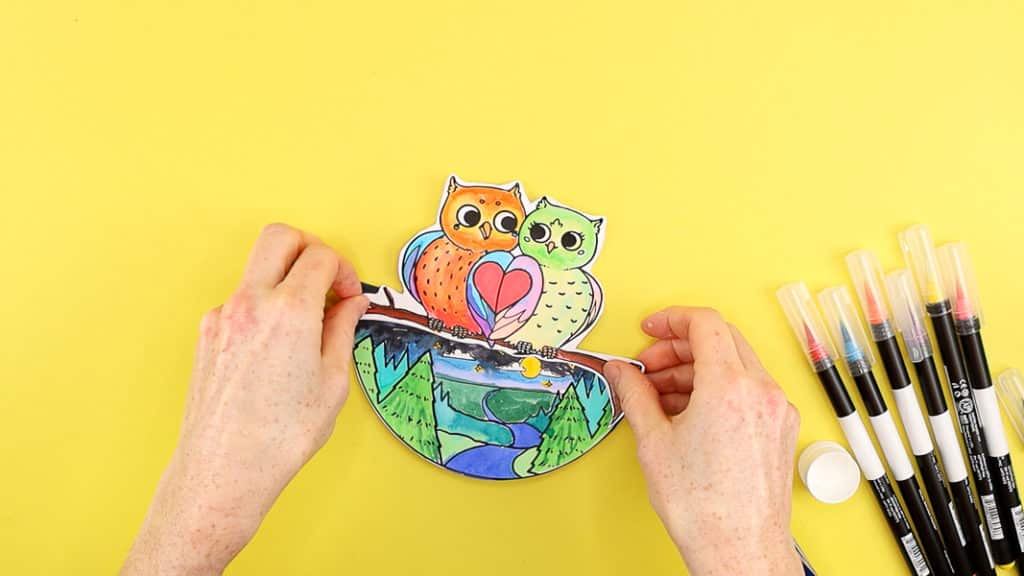 Affix the pair of owls along the top fold of the rocking card base. 