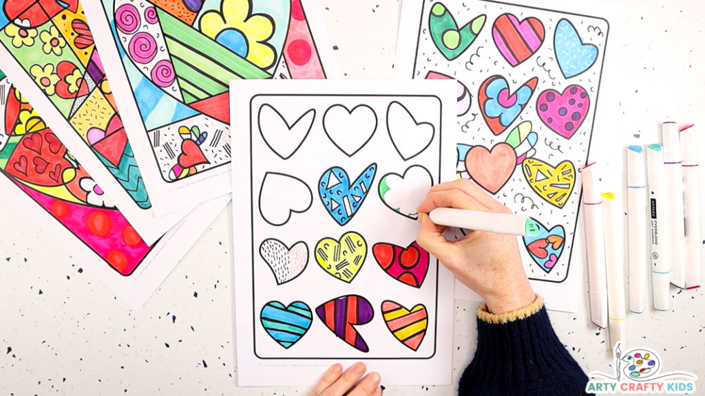 The image features a hand drawing colorful illustrations of dots and stripes within the hearts.