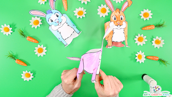 Hands holding the bunny on a side angle to demonstrate the 3D effect.