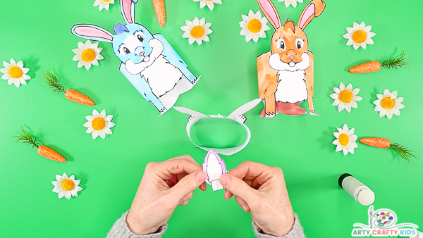 Image featuring hands holding the tail to illustrate where to add the fold and glue.