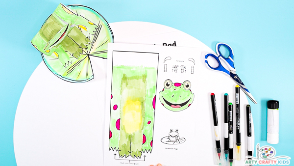 Image featuring a completed colored in frog that's multiple shades of green with pink spots.