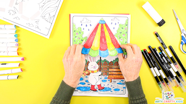 Affix the umbrella to the bunny coloring page to create a 3D effect.
