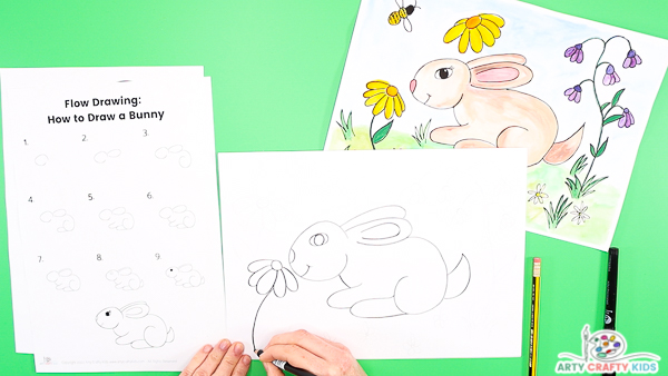 Draw flowers around the bunny drawing.