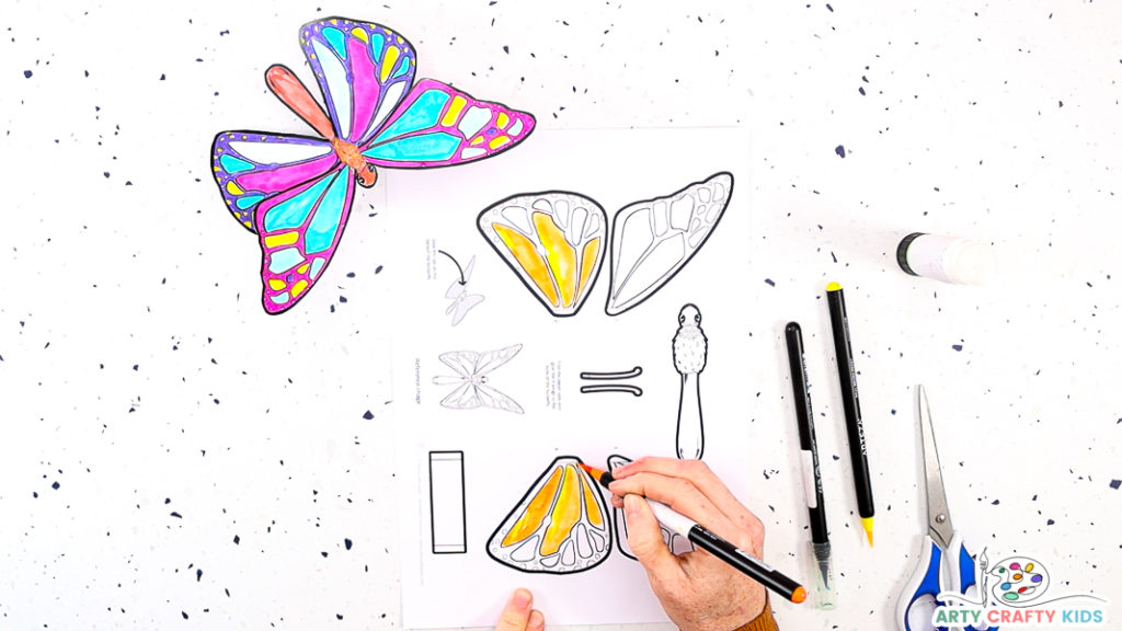 Image featuring a hand coloring in the butterfly template.