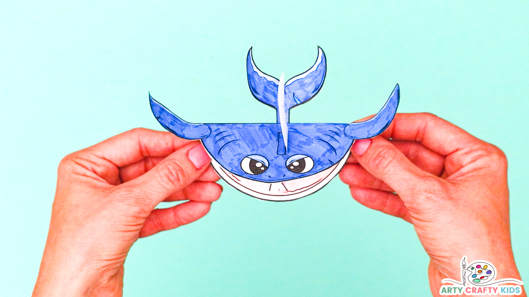 Completed 3D printable shark craft held in hands, mouth closed
