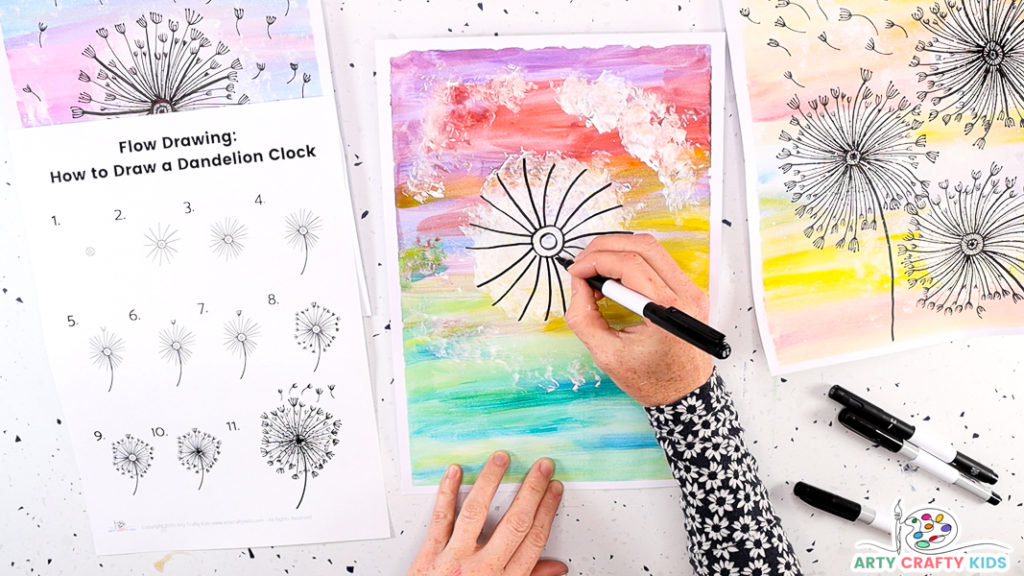 This image features a hand continuing to draw lines from the center circle that spread from the center to the tips of the large white dandelion puff.