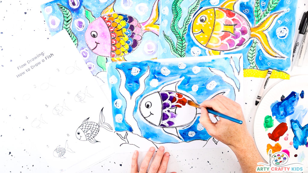 Image featuring a hand spreading purple and red watercolor paint to the fish body.