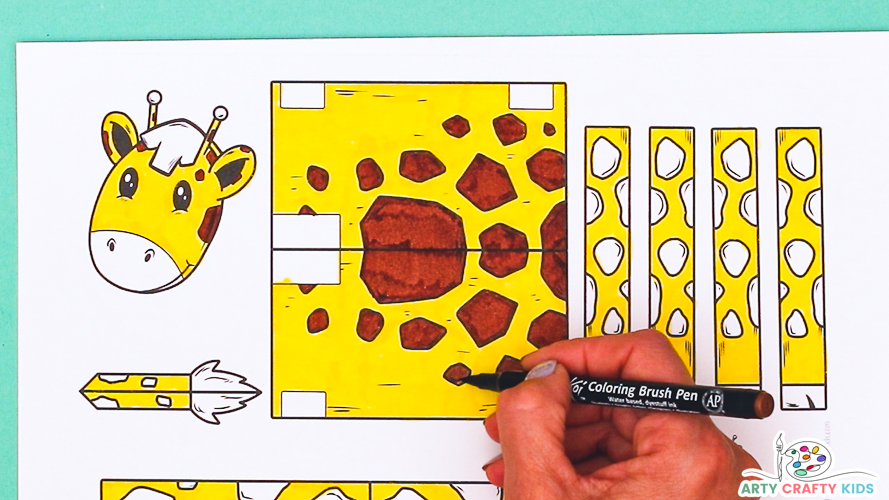 Image featuring a hand coloring in the printable giraffe craft template with watercolor pens.